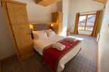 Experience cozy comfort in this charming bedroom.