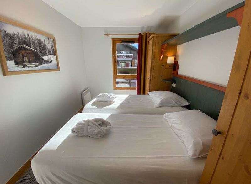 Cozy bedroom featuring two comfortable beds, perfect for a relaxing stay.