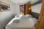 Cozy bedroom featuring two comfortable beds, perfect for a relaxing stay.