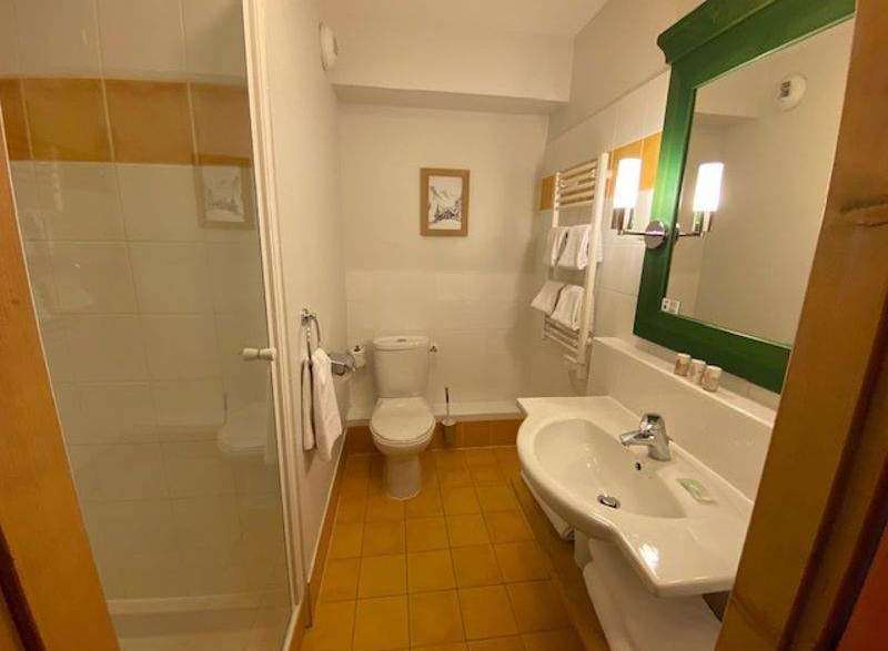 This cozy bathroom features a bright and airy design with a modern sink and a refreshing shower.