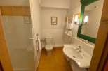 This cozy bathroom features a bright and airy design with a modern sink and a refreshing shower.