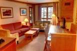 This cozy living space features a comfortable red sofa and armchairs, perfect for relaxing after a day of exploring.