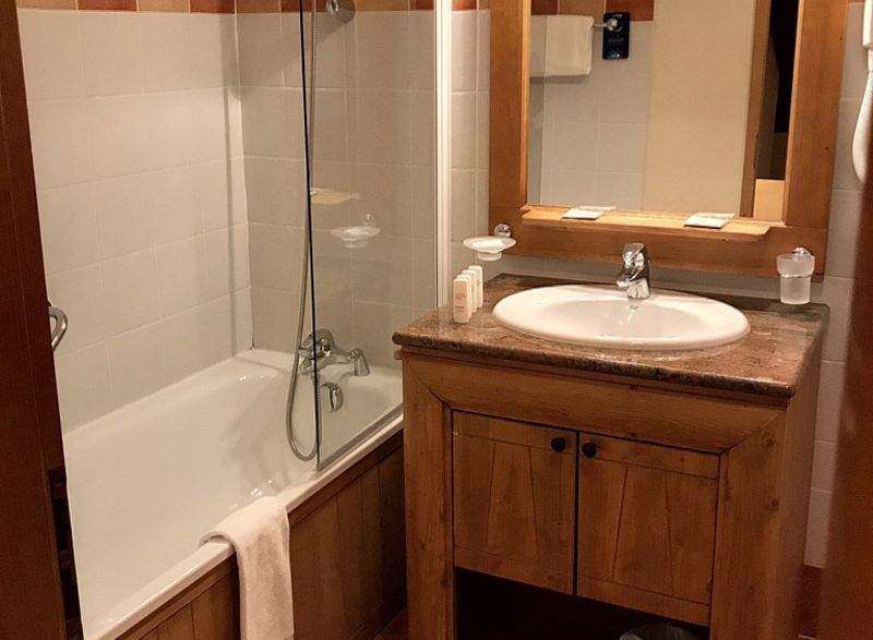 This cozy bathroom features a bathtub with a shower, perfect for a relaxing soak.