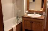 This cozy bathroom features a bathtub with a shower, perfect for a relaxing soak.