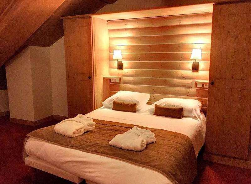 Cozy bedroom with wooden accents and warm lighting.