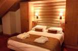 Cozy bedroom with wooden accents and warm lighting.