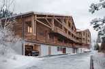 Experience the charm of this stunning wooden chalet, perfectly nestled in a snowy landscape.