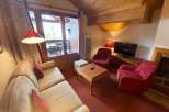 Cozy living room with a comfortable sofa and two armchairs, perfect for relaxing after a day of exploring.