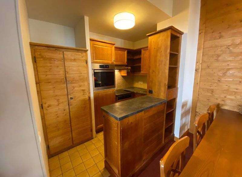 This charming kitchen features warm wooden cabinetry and a cozy dining area.