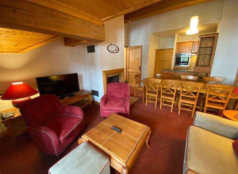 This cozy living space features a comfortable seating area with plush armchairs and a stylish coffee table.