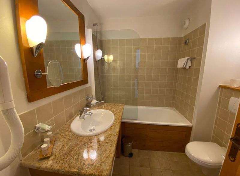 This bathroom features a stylish design with a modern sink and a well-lit vanity area.