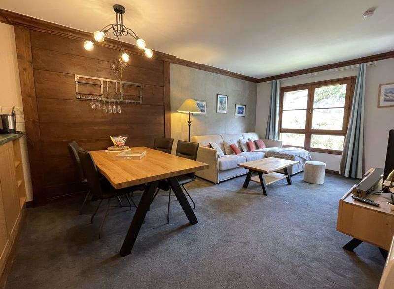 Discover a cozy living space with a stylish dining area and comfortable seating.