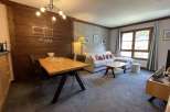 Discover a cozy living space with a stylish dining area and comfortable seating.