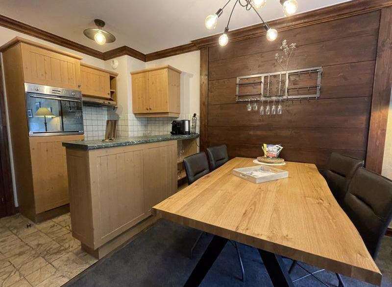 This charming kitchen boasts a rustic design with wooden cabinetry and a stylish dining area.