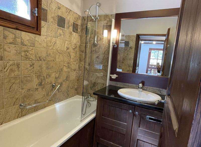 Step into this charming bathroom featuring a classic bathtub and a stylish vanity.