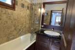 Step into this charming bathroom featuring a classic bathtub and a stylish vanity.