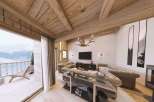Experience luxury living in this stunning property, featuring a cozy fireplace and a breathtaking mountain view from the balcony.