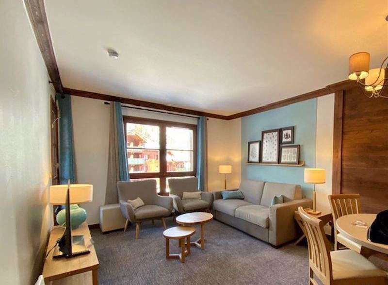 This cozy living space features a comfortable sofa and two armchairs, perfect for relaxing after a day of exploring.