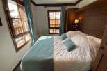 Cozy bedroom with a comfortable bed and soft bedding.