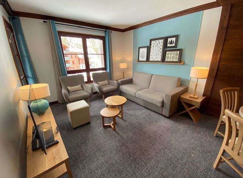 Cozy living space with a comfortable sofa and armchairs, perfect for relaxation.