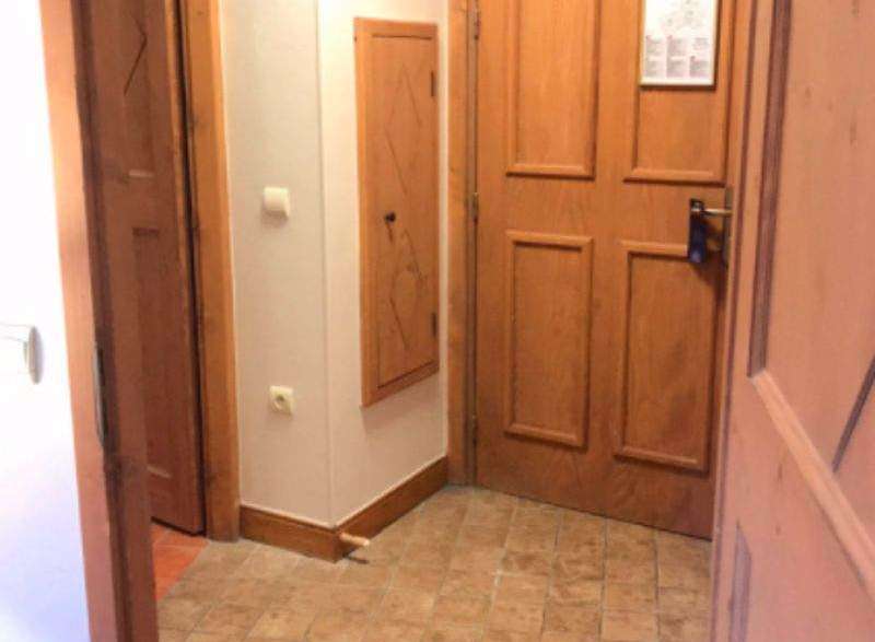 Step into a warm and inviting space with this property's charming wooden doors and tiled flooring.