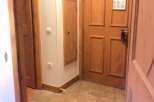 Step into a warm and inviting space with this property's charming wooden doors and tiled flooring.