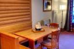 This charming property features a cozy dining area with a wooden table and chairs, perfect for enjoying meals.