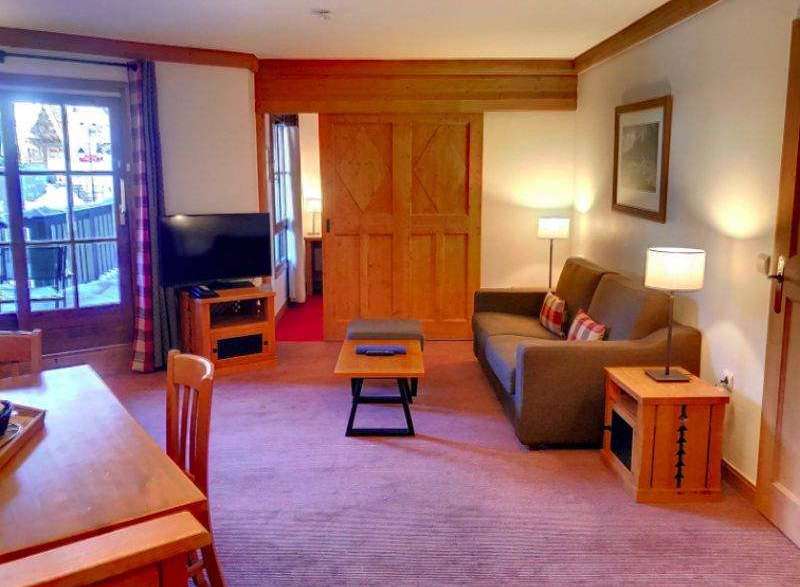 Discover a cozy living space with a comfortable sofa and stylish wooden furniture.