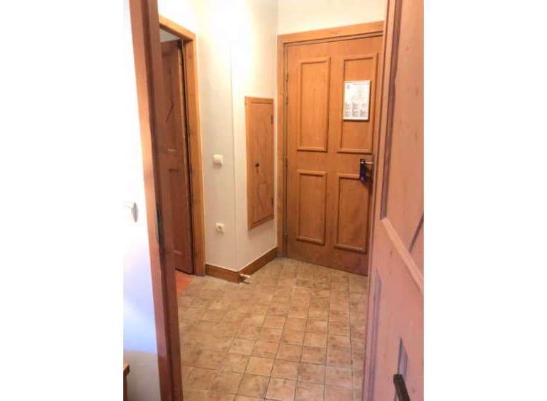 Step into this charming entryway featuring a warm wooden door and a convenient built-in cabinet.
