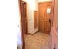 Step into this charming entryway featuring a warm wooden door and a convenient built-in cabinet.