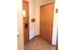 Step into this charming entryway featuring a warm wooden door with a convenient 'Do Not Disturb' sign, perfect for ensuring privacy.