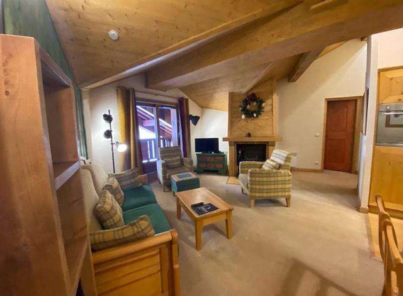 Cozy up in this charming living space, featuring a warm fireplace and inviting seating.