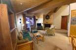 Cozy up in this charming living space, featuring a warm fireplace and inviting seating.