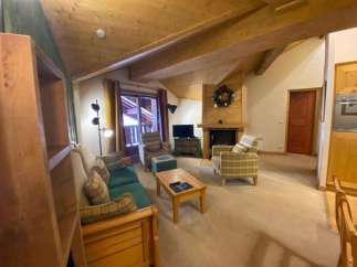 Cozy up in this charming living space, featuring a warm fireplace and inviting seating.