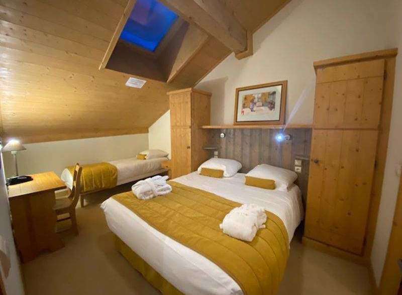 Discover a cozy retreat in this charming room, featuring a comfortable bed and a warm, inviting atmosphere.