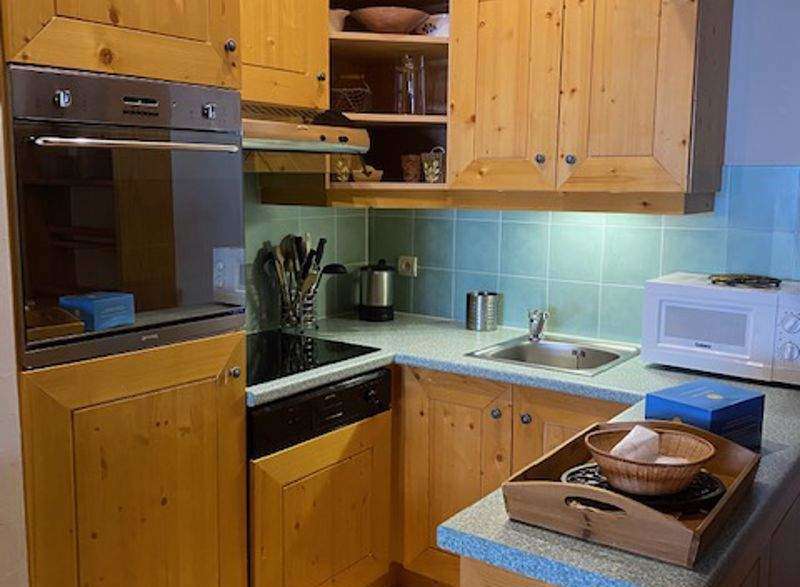 This charming kitchen features warm wooden cabinetry, creating a cozy and inviting atmosphere.