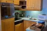 This charming kitchen features warm wooden cabinetry, creating a cozy and inviting atmosphere.