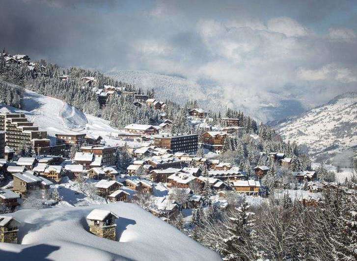 Experience the charm of a snow-covered village nestled in the mountains.