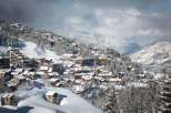 Experience the charm of a snow-covered village nestled in the mountains.