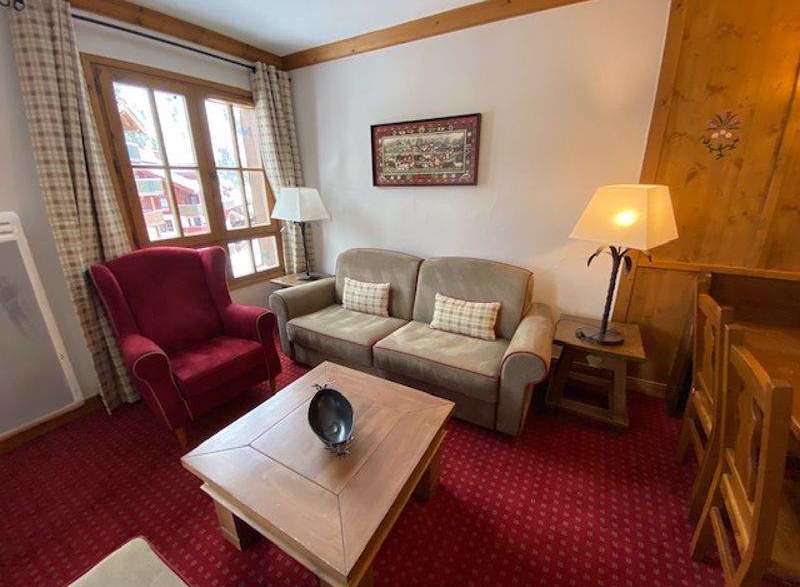 Cozy living room with a comfortable sofa and armchair, perfect for relaxing after a day of exploring.
