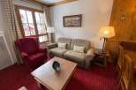 Cozy living room with a comfortable sofa and armchair, perfect for relaxing after a day of exploring.