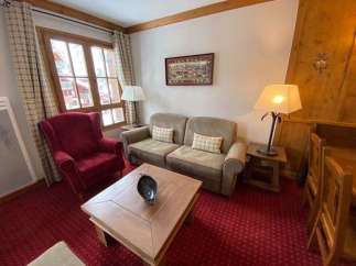Cozy living room with a comfortable sofa and armchair, perfect for relaxing after a day of exploring.