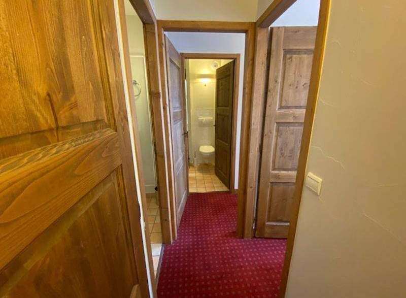 Explore this charming property featuring warm wooden doors and a cozy red carpet.