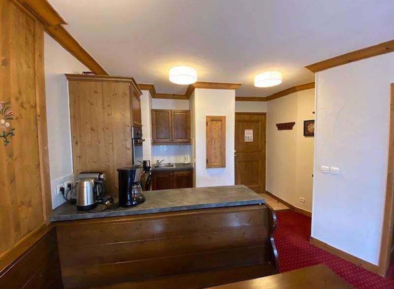 Cozy kitchen with wooden cabinets and a countertop, perfect for preparing meals.