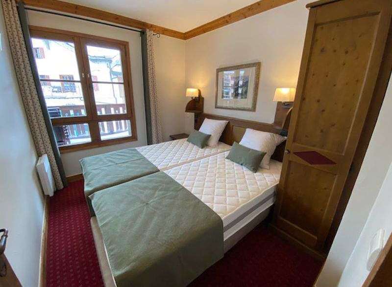 Cozy bedroom featuring two twin beds with comfortable mattresses and soft bedding.