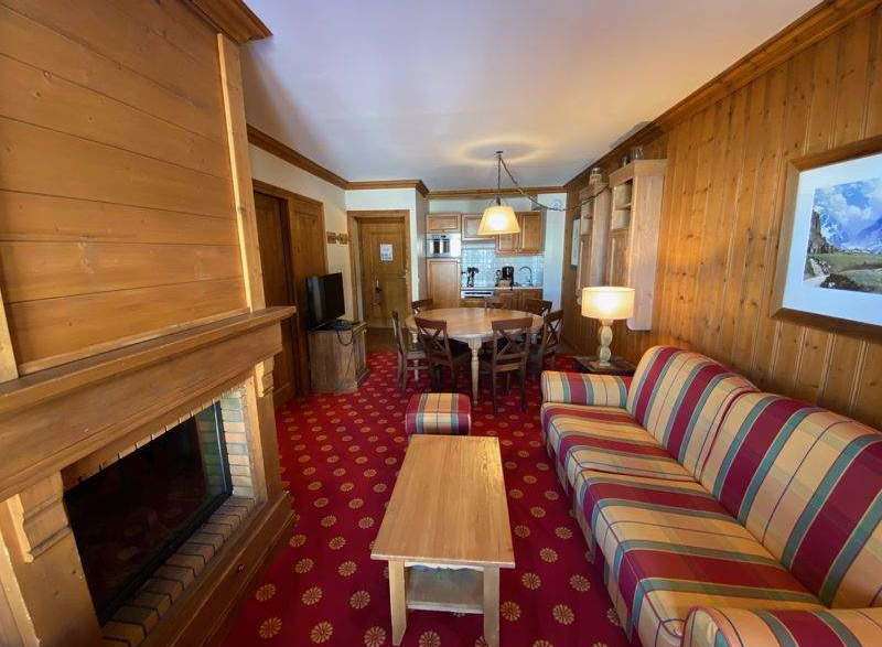 Cozy up in this charming living space, featuring a warm fireplace and inviting seating.