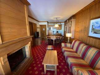 Cozy up in this charming living space, featuring a warm fireplace and inviting seating.
