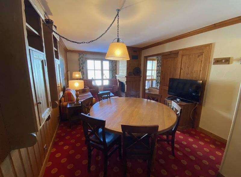 This charming property boasts a cozy dining area with a round wooden table, perfect for gatherings.