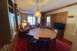 This charming property boasts a cozy dining area with a round wooden table, perfect for gatherings.