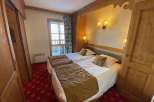 Cozy bedroom featuring two twin beds with plush bedding and decorative pillows.